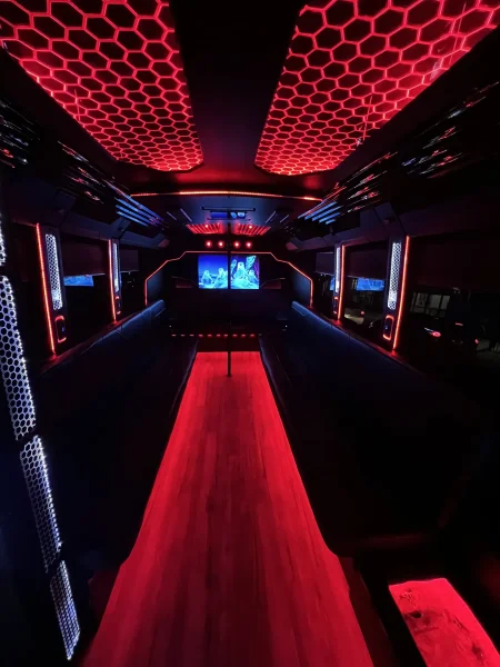 Party Bus - Red LED honeycomb ceiling and dance pole interior - Dallas VIP Transportation