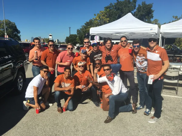 Texas vs OU - Longhorns fans pose by the tailgate tents with the Dallas skyline behind - Dallas VIP
